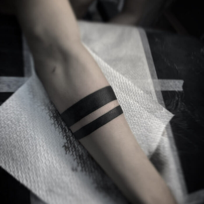 Foto de un tatuaje realizado por el tatuador Gennaro sacco en kaifa´s tattoo Studio Madrid, con estilo dotwork, con materiales cruelty free, tattoo de 2 lineas rayas en brazo